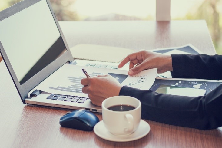 Business Development, printed growth graph on an open laptop computer on a desk